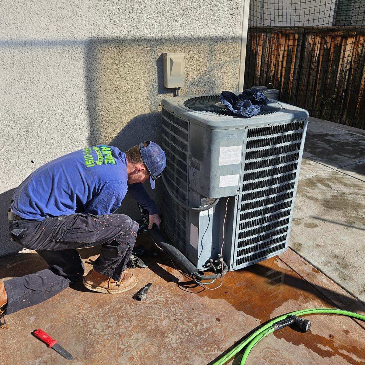 Airtime tech repairing HVAC unit