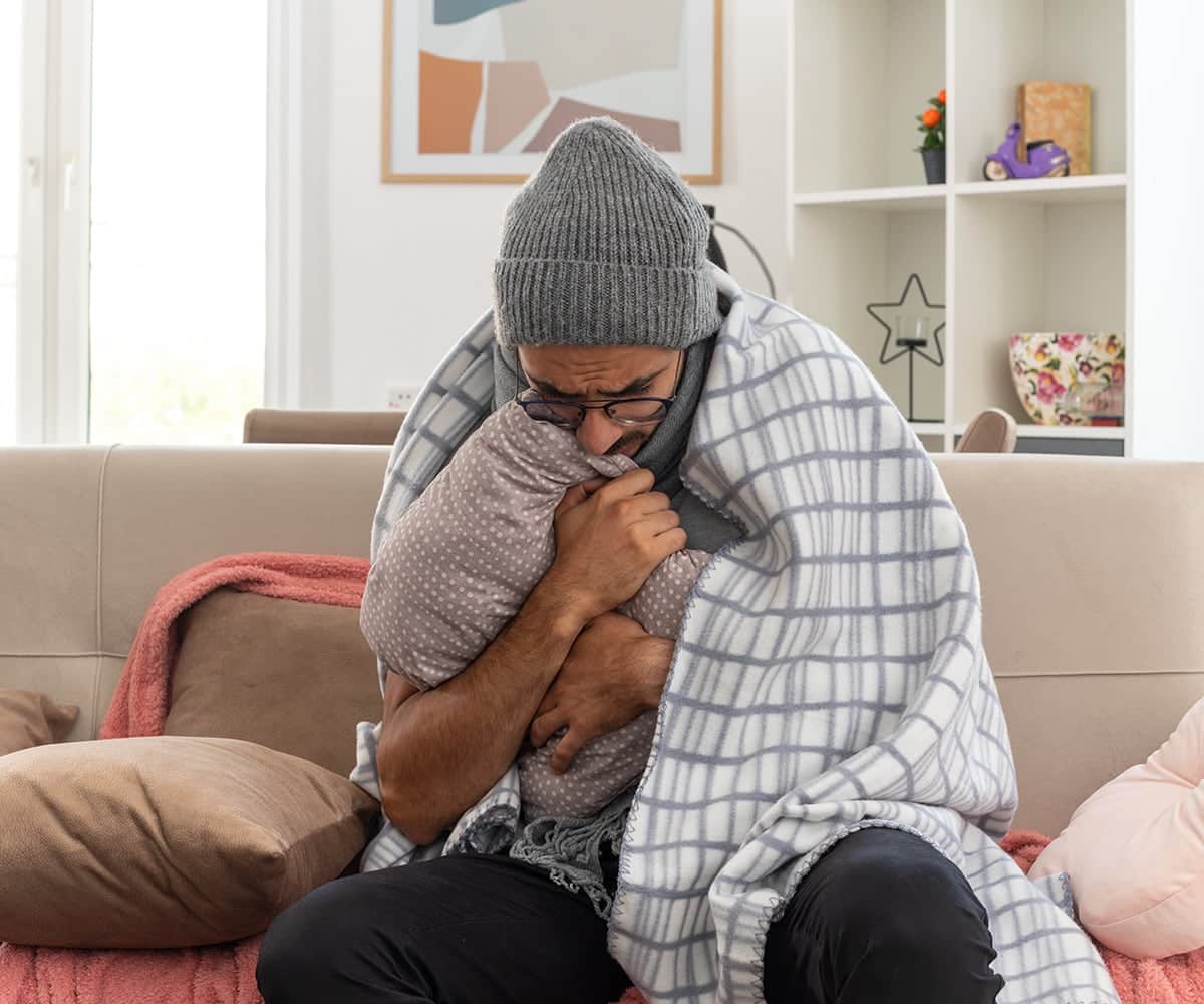 man covered in blanket